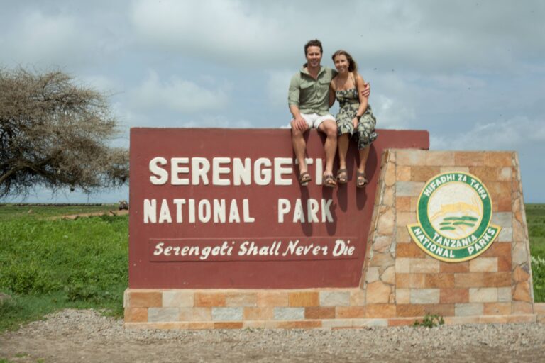 Travellers at the Serengeti National Park gate, one of the best places to visit in Tanzania